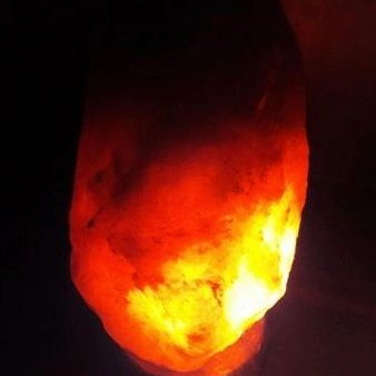 Salt lamp glowing warmly on a dark background