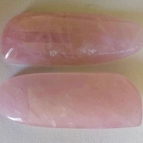 Two pink wands on a white background