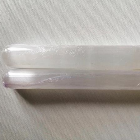 Two Selenite wands on a white background