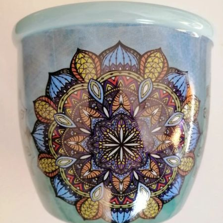 Ceramic smudge stick container with a colorful mandala design on a light blue background