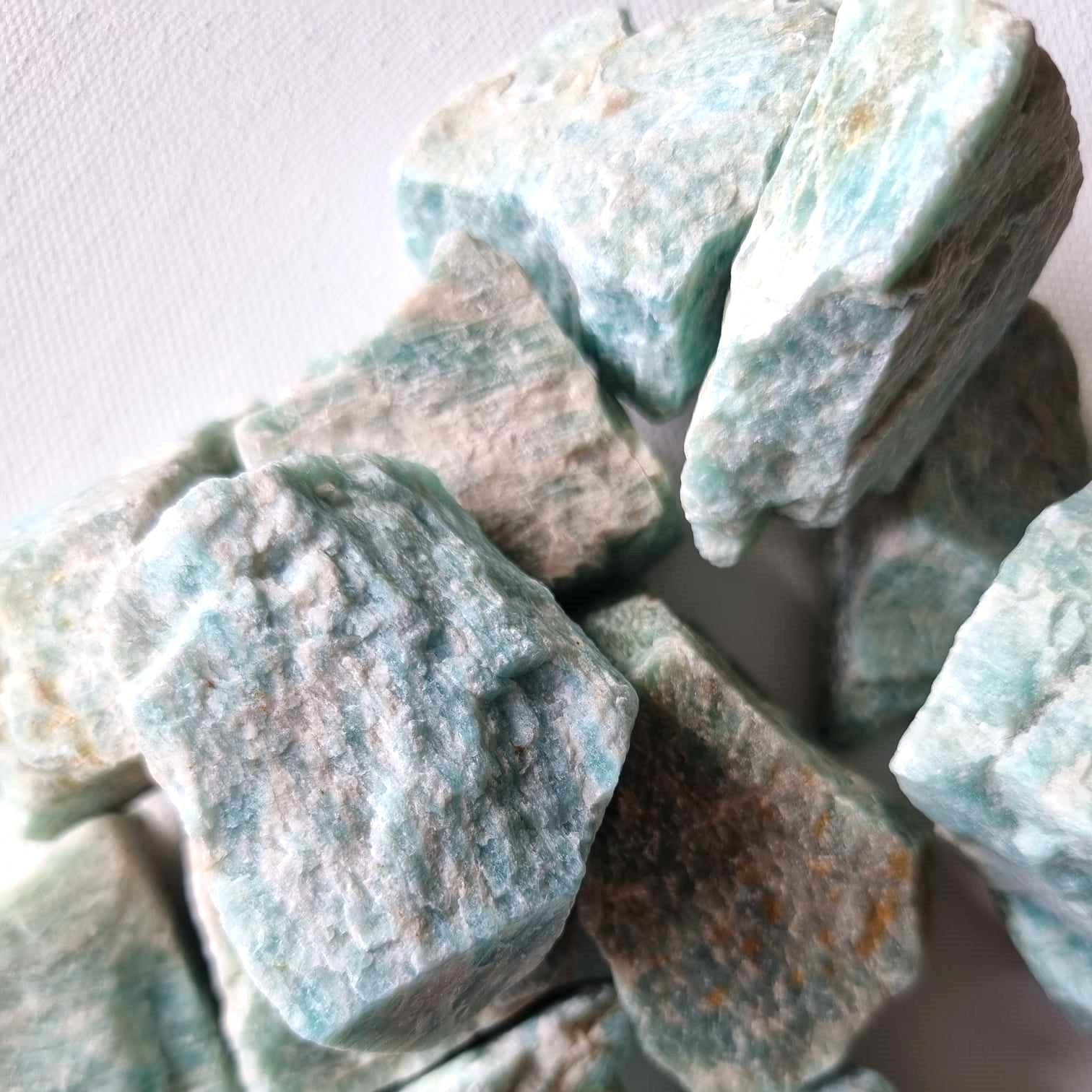 Close-up of rough turquoise stones on a white background