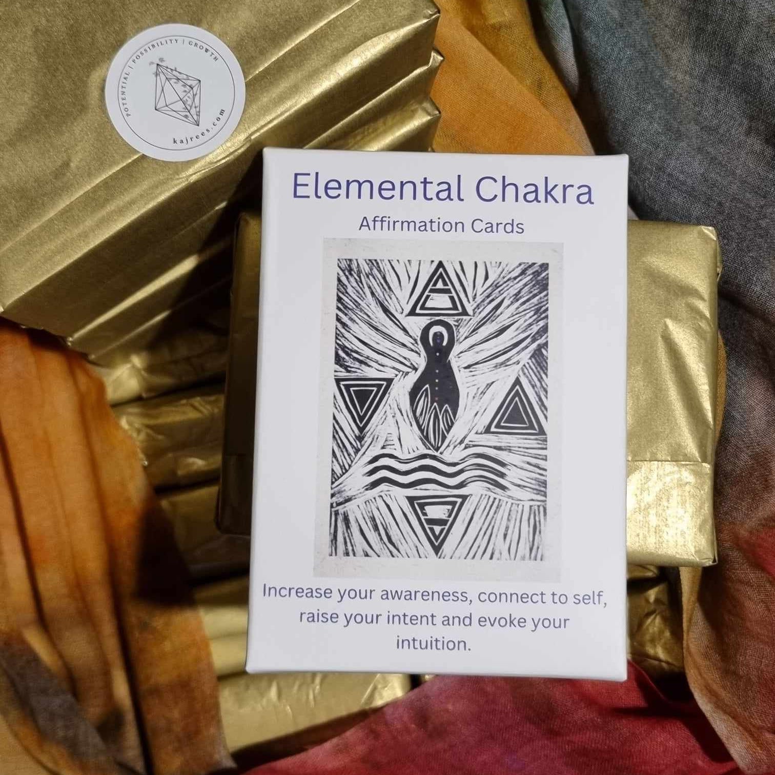 Elemental Chakra affirmation cards on a colorful fabric background