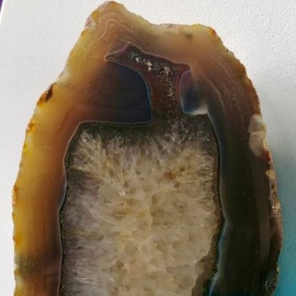 Geode with a rough, multicolored interior on a white background