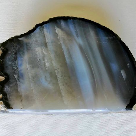 Geode slice with layered crystal structure on a white background