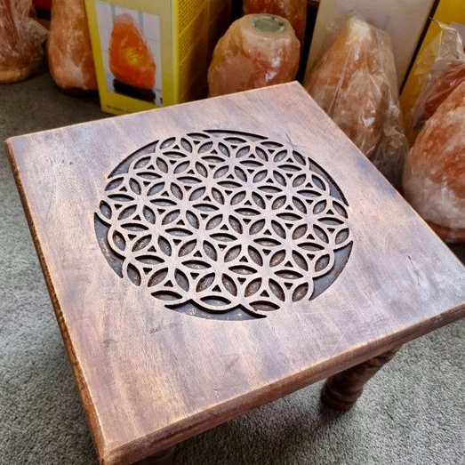 Wooden table with geometric design in front of salt lamp boxes