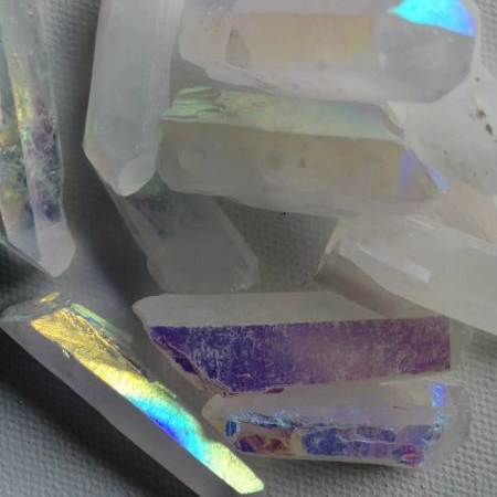 Iridescent raw crystal points on a textured surface