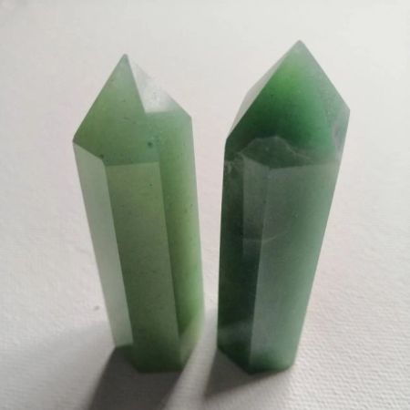 Two green crystal points on a white background