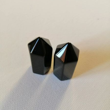 Two small black points on a beige surface