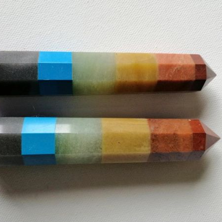 Two colorful crystal wands with a grid pattern on a white background