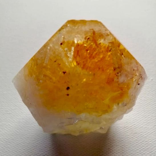 Yellow crystal on a white background