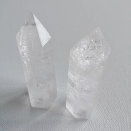 Two crystal points on a light gray background