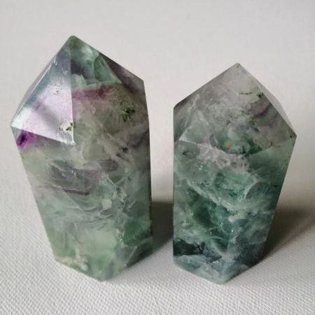 Two crystal points on a white background