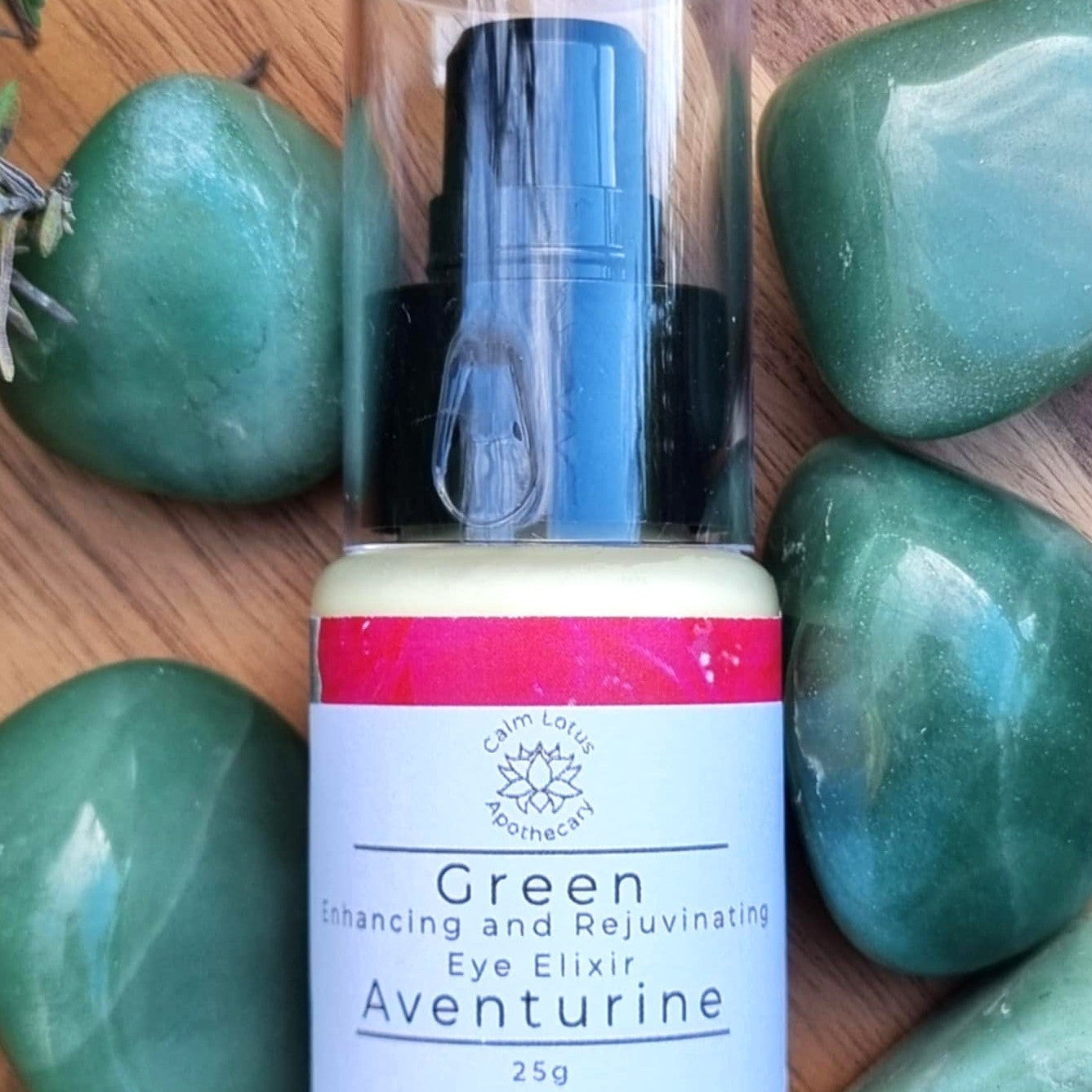 Bottle of Aventurine Eye Elixir with a label on green stones