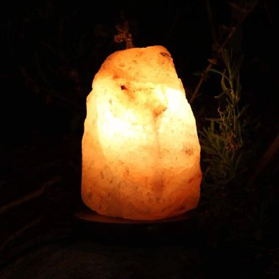 Himalayan salt lamp glowing warmly against a dark background