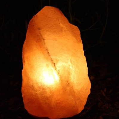 Luminous salt lamp on a dark background