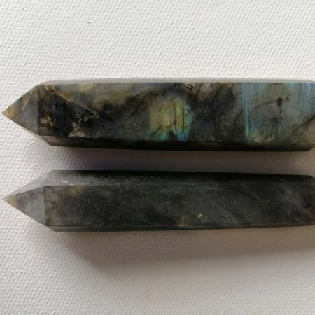 Two crystal wands on a white fabric background