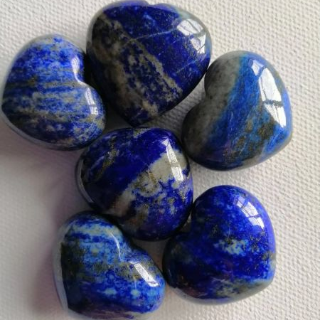Heart-shaped lapis lazuli stones on a white background