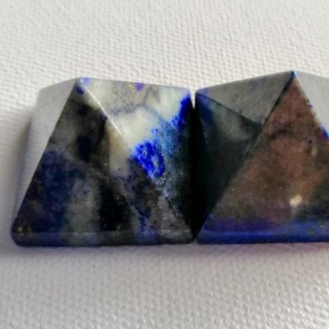 Two lapis pyramids on a white background