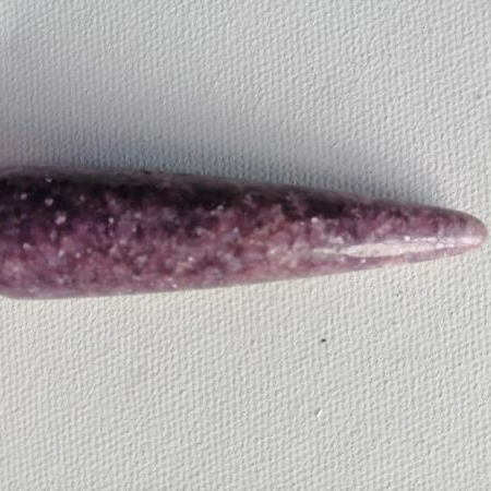 Purple crystal wand on a light gray background