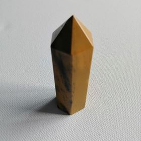 Mustard coloured point on a textured gray surface