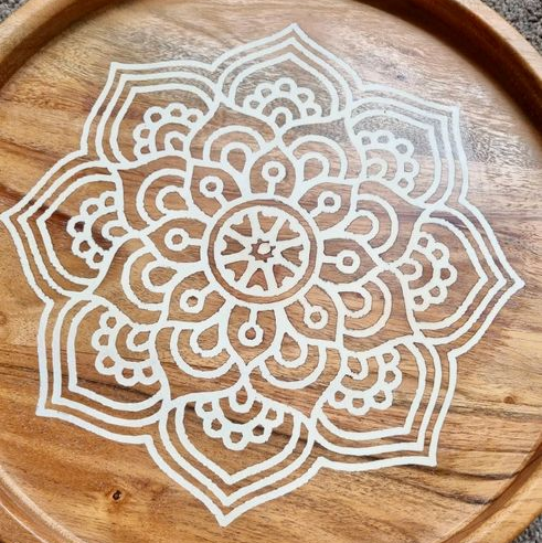 Wooden tray with a white mandala design