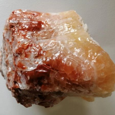 Rainbow Calcite with a rough surface on a white background