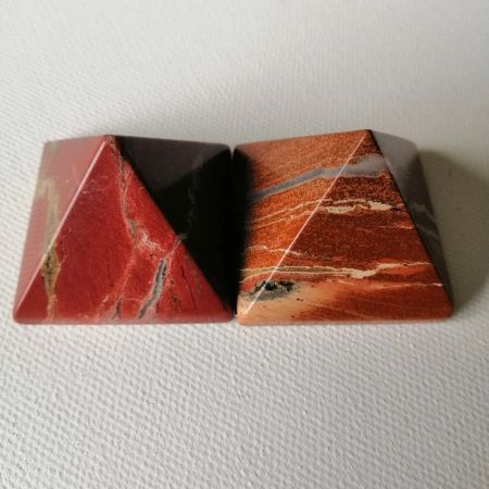 Red Jasper pyramids on a white background