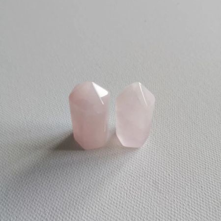 Two pink crystal mini points on a light gray background