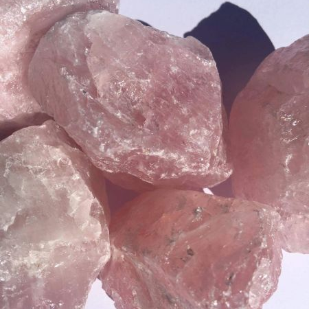 Close-up of pink crystal rocks against a light blue background