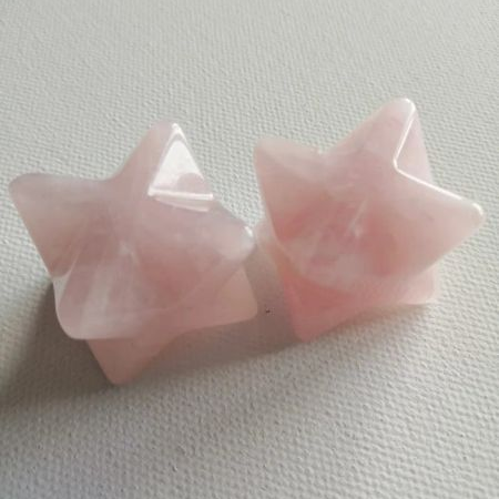 Pink star-shaped crystals on a light gray background
