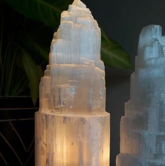 Selenite tower lamp, on a dark background.