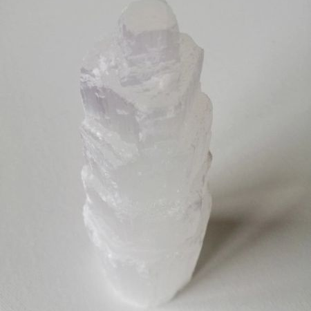 Selenite crystal tower on a white background