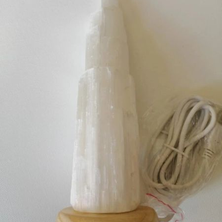 Selenite tower USB lamp with wooden base on a white background