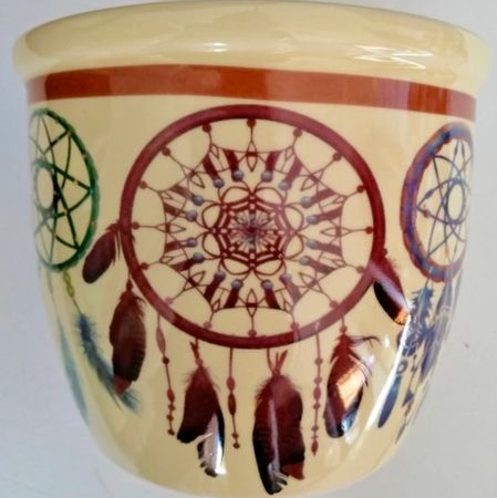 Ceramic smudge stick/candle holder with dreamcatcher design on a white background