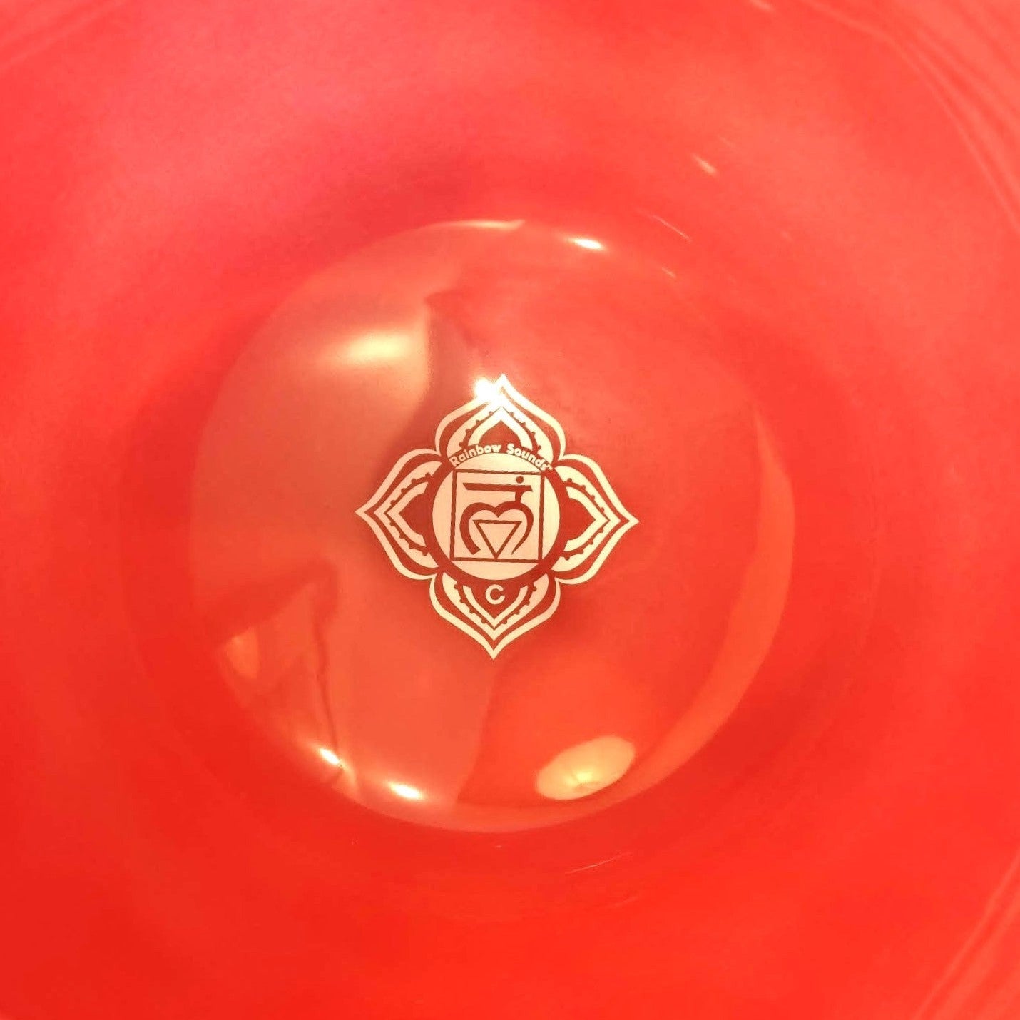 Red bowl with a root chakra logo in the center
