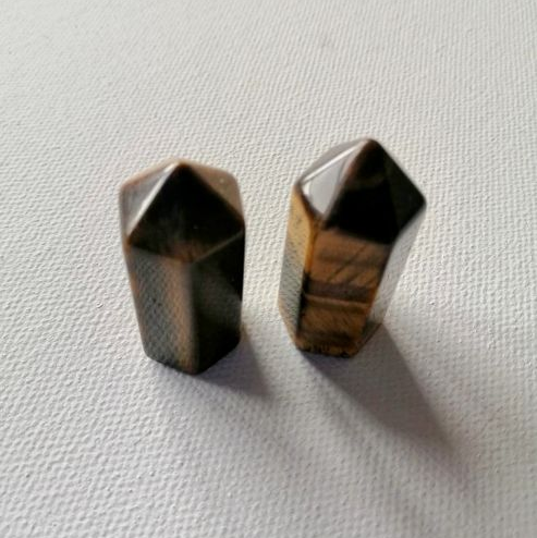 Two mini points of Tiger Eye on a white background